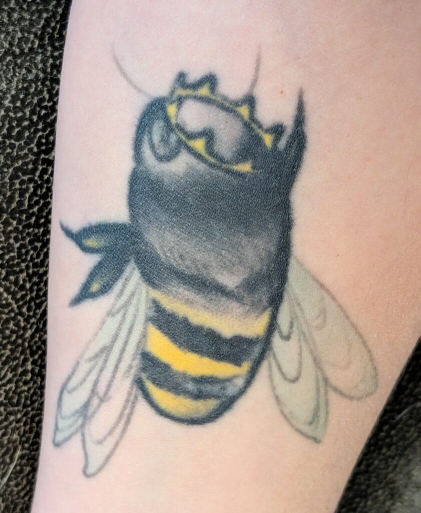 A stylized tattoo of a Queen Bee with a Crown